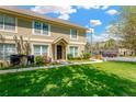 Townhome exterior with lush green lawn, set in a well-maintained community under a sunny sky at 2897 Thaxton Dr # 62, Palm Harbor, FL 34684
