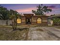 Charming single-story home featuring a decorative stone facade and a beautiful sunset backdrop at 3443 16Th Ave S, St Petersburg, FL 33711