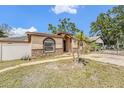 Charming single-story home featuring a decorative stone facade, driveway, and partial fencing at 3443 16Th Ave S, St Petersburg, FL 33711