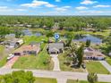 Expansive aerial view of home, showcasing its picturesque location on a lake at 3626 Lake Joyce Dr, Land O Lakes, FL 34639