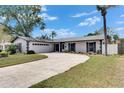 Well-manicured lawn complements this beautiful single-story home featuring a spacious driveway and attached two-car garage at 4704 Travertine Dr, Tampa, FL 33615