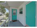 Unit entrance featuring a teal door with number 10 and a small balcony at 5810 21St N St # 10, St Petersburg, FL 33714