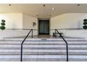 Elegant condominium building entrance featuring stairs and prominent double doors at 5940 Pelican Bay S Plz # 504, Gulfport, FL 33707