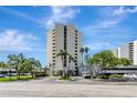 Modern condo building with lush landscaping and ample parking at 5940 Pelican Bay S Plz # 504, Gulfport, FL 33707