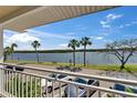 Balcony view showcasing waterfront scenery with palm trees under a bright sky at 611 Destiny Dr # 205, Ruskin, FL 33570