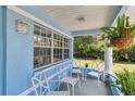 Cozy front porch featuring comfortable seating and a view of the landscaped yard at 711 6Th Ne St, Largo, FL 33770