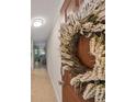 Close-up of the front door featuring a welcoming wreath and modern hardware at 10100 Sailwinds N Blvd # 203, Largo, FL 33773