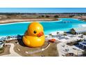 Wonderful aerial view of a giant rubber duck near the turquoise blue lagoon and sandy beach at 11014 Rustic Timber Loop, San Antonio, FL 33576