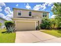 Two-story home with manicured lawn, neutral siding, and a two car garage at 11231 Spring Point Cir, Riverview, FL 33579