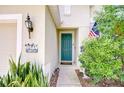 Up close, the home's front door is accented by a themed plaque, snake plants, and a decorative dog at 11231 Spring Point Cir, Riverview, FL 33579
