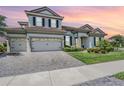 Charming two-story home with a brick driveway, well-manicured lawn, and a tile roof at 13121 Pasture View Loop, Riverview, FL 33579