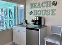 Convenient kitchenette with granite countertop, mini-fridge, and stylish decor, ideal for a quick snack or beverage at 13200 Boca Ciega Ave, Madeira Beach, FL 33708