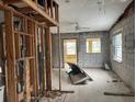 Renovation project shows a living room with exposed beams, hardwood floor and block walls ready for customization at 13200 Boca Ciega Ave, Madeira Beach, FL 33708