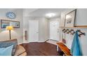 Welcoming foyer with hardwood floors, natural light, and a cozy seating area at 13308 Kearney Way, Tampa, FL 33626