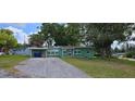 Charming single-story home featuring a well-maintained lawn and mature trees at 1615 Stevensons Dr, Clearwater, FL 33755