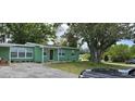 Charming single-story home featuring a well-maintained lawn and mature trees at 1615 Stevensons Dr, Clearwater, FL 33755