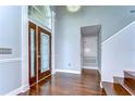 Elegant entryway with hardwood floors, chandelier, and decorative front door with glass panels at 1632 Gray Bark Dr, Oldsmar, FL 34677