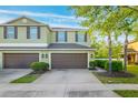 Well-maintained townhome boasts a two-car garage, complemented by verdant landscaping and a pristine driveway at 20224 Pond Apple Ln, Tampa, FL 33647