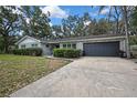 Charming single-story home featuring a brick facade, well-maintained landscaping, and a two-car garage at 215 Deer Park Ave, Temple Terrace, FL 33617