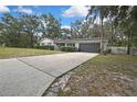 Charming single-story home featuring a brick facade, well-maintained landscaping, and a two-car garage at 215 Deer Park Ave, Temple Terrace, FL 33617