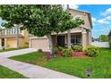 Inviting two-story home featuring a green lawn, a attached garage and a landscaped garden at 2800 Flagler Ct, Trinity, FL 34655