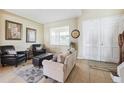 Cozy living room featuring tile floors, natural light and comfortable seating arrangements at 2800 Flagler Ct, Trinity, FL 34655