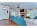 Cozy living room with a stone fireplace, wood floors, and plenty of natural light at 2927 Hickory Grove Dr, Valrico, FL 33596