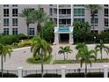 Elegant condo entrance with lush tropical landscaping and a stylish portico at 331 Cleveland St # 320, Clearwater, FL 33755