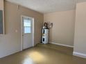 The garage features a painted floor, access door, and water heater at 3355 Abeline Rd, Spring Hill, FL 34608