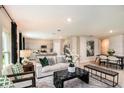Bright open-concept living room and kitchen with modern decor and plenty of natural light at 37213 Sagemoor Dr, Zephyrhills, FL 33541