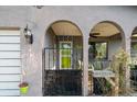 Inviting front porch with decorative arches, metal gate, and a bright green front door with a 'Welcome' sign at 3961 15Th N Ave, St Petersburg, FL 33713