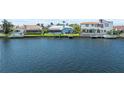 Waterfront view of the house, neighboring properties, and private docks, perfect for boaters at 5104 E Longboat Blvd, Tampa, FL 33615