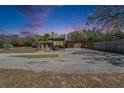 Charming one-story home featuring a screened-in porch and a large driveway at 827 Louise St, Brandon, FL 33511