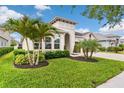 Lush front yard with mature landscaping highlights this charming home with a two-car garage and inviting entrance at 1106 Tracey Ann Loop, Seffner, FL 33584