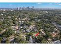 Aerial view of home in a neighborhood with a skyline view; house location indicated with red arrow at 115 21St Ne Ave, St Petersburg, FL 33704