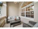 Inviting front porch with a seating area perfect for relaxing and enjoying the outdoors at 121 Colonial Sw St, Port Charlotte, FL 33952