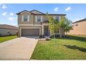 Charming two-story home with a well-manicured lawn and a two-car garage, ideal for Gathering living at 1547 Golden Glow Dr, Ruskin, FL 33570