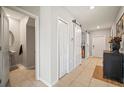 Hallway featuring white sliding doors and neutral walls, showcasing a clean and modern design at 1547 Golden Glow Dr, Ruskin, FL 33570