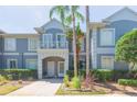 Inviting condo exterior features a private balcony, manicured hedges, and a well-maintained walkway at 18236 Paradise Point Dr, Tampa, FL 33647