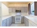 Bright kitchen featuring sleek countertops, stainless steel microwave, and ample cabinet storage at 18236 Paradise Point Dr, Tampa, FL 33647