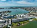 A scenic view of a condo building with beautiful landscaping, a pier, and a pool in a coastal community at 1847 Shore S Dr # 507, South Pasadena, FL 33707