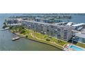 Aerial view shows the building, expansive lawns, a pool and a dock at 1847 Shore S Dr # 507, South Pasadena, FL 33707