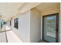 Neutral hallway showing the entrance to the unit with a window on the side at 19531 Gulf Blvd # 210, Indian Shores, FL 33785