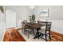 Light and bright dining area with wood floors and a modern chandelier at 20403 Walnut Grove Ln, Tampa, FL 33647