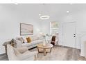 Bright living room with lots of light features modern décor, hardwood floors, contemporary lighting, and neutral colors at 2410 W North A St # 2, Tampa, FL 33609