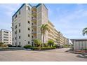 Multi-story condominium with blue accents, manicured landscaping, and ample parking at 2960 59Th S St # 615, Gulfport, FL 33707