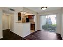 Open concept living area with bar seating and sliding glass doors at 3206 W Azeele St # 126, Tampa, FL 33609