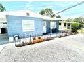 A well-kept single story home with blue siding, a rock yard, and a cute planter by the front door at 3318 Boca Ciega N Dr, St Petersburg, FL 33710