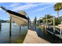 View of a private boat dock with boat lift system on a sunny day at 3918 Versailles Dr, Tampa, FL 33634