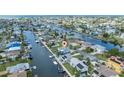 Aerial view of waterfront neighborhood, highlighting canal access and proximity to open water at 4290 Carlos Ct, Hernando Beach, FL 34607